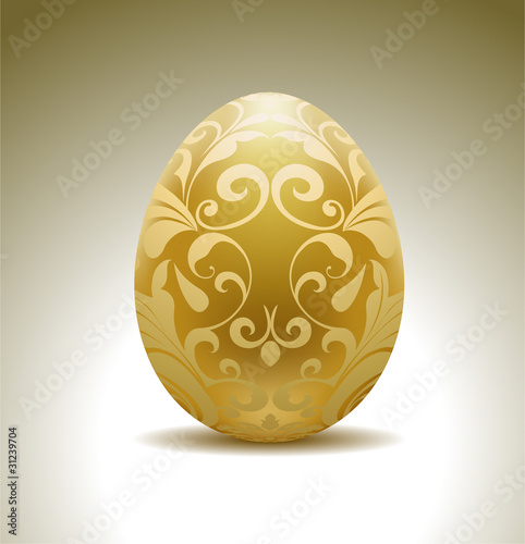 Golden egg with floral decoration.