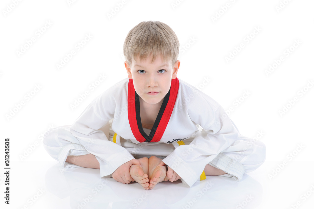 Boy in a kimono sits on a floor Boy in a kimono sits on a floor