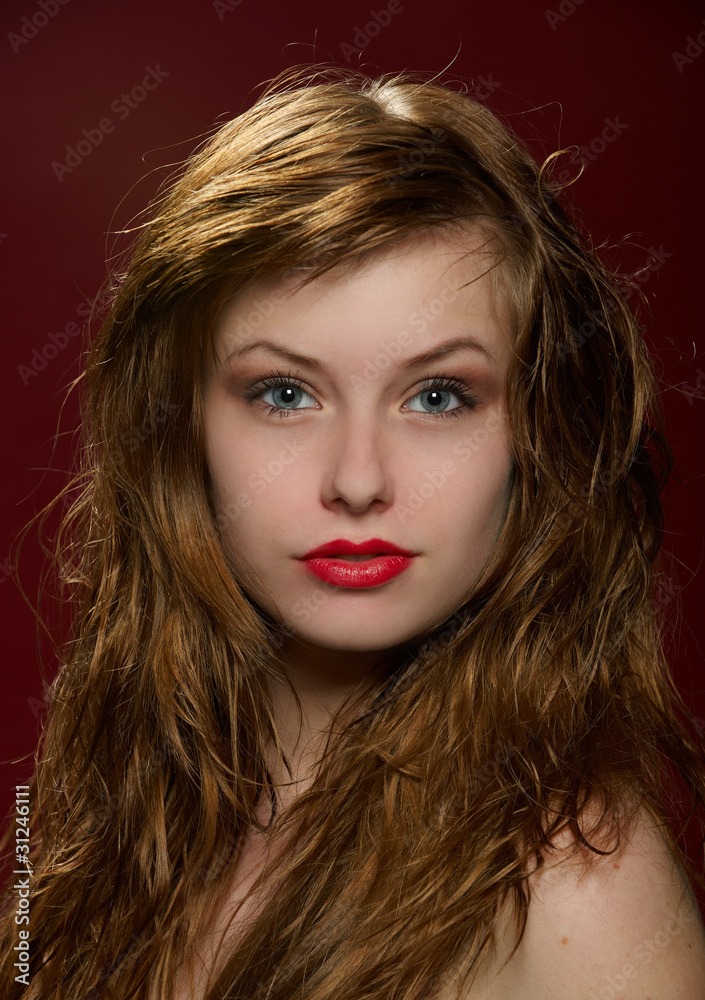 Fototapeta premium Portrait of attractive red-haired young girl with classical glam