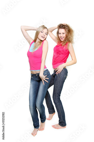 two young attractive women dancing over white