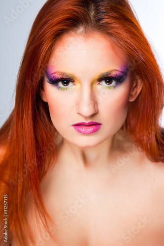 Portrait of aggressive woman with multicolored make-up