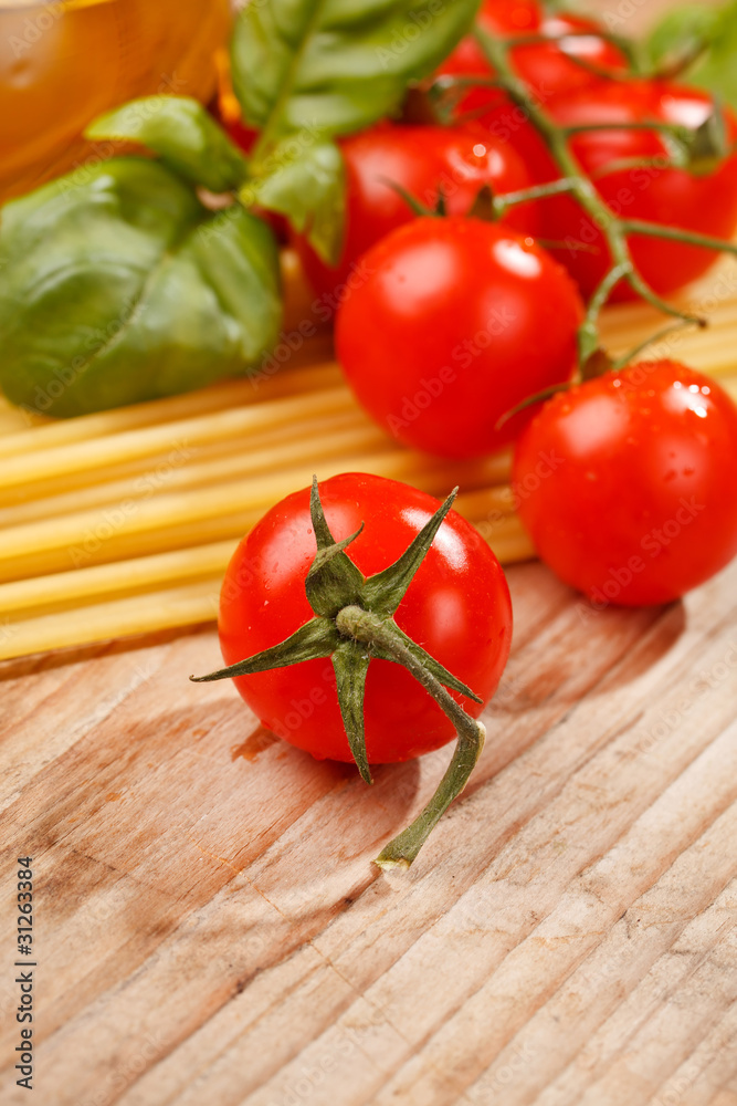 pasta, olive oil and tomatoes on the wood background pasta, olive oil and tomatoes on the wood background