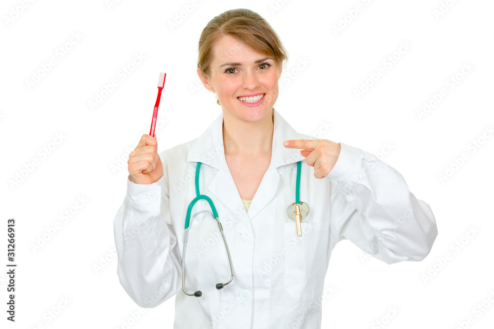 Dentist female pointing on toothbrush. Concept - healty teeth. Dentist female pointing on toothbrush. Concept - healty teeth.