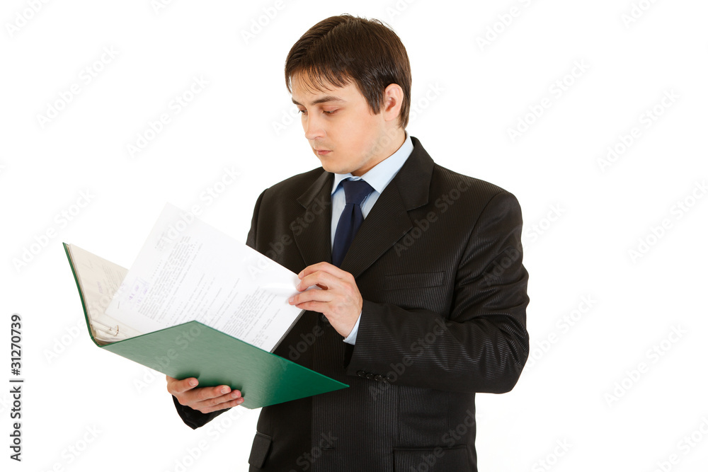 Concentrated modern businessman checking documents Concentrated modern businessman checking documents