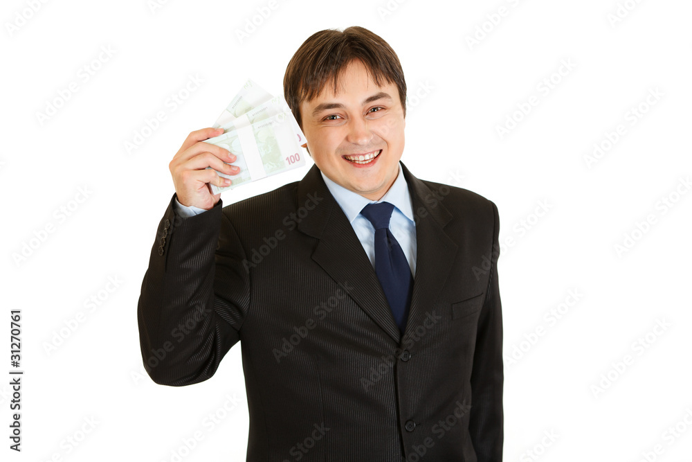 Smiling modern businessman holding euro packs in his hand Smiling modern businessman holding euro packs in his hand