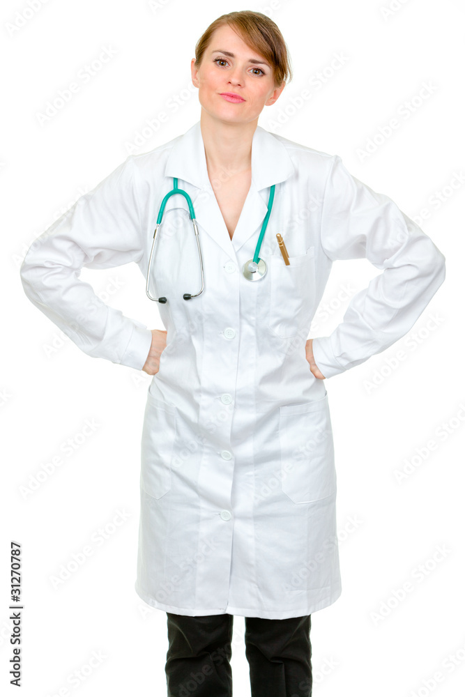 Displeased medical doctor woman holding hands on hips Displeased medical doctor woman holding hands on hips