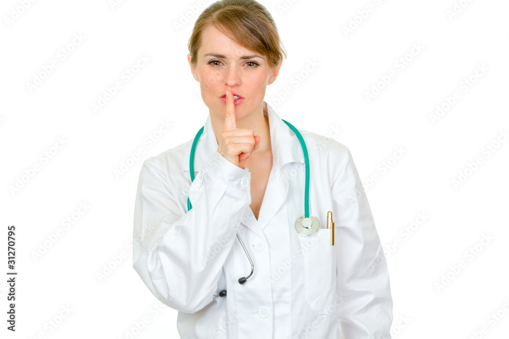 Authoritative doctor woman with finger at mouth. Shh gesture. Authoritative doctor woman with finger at mouth. Shh gesture.