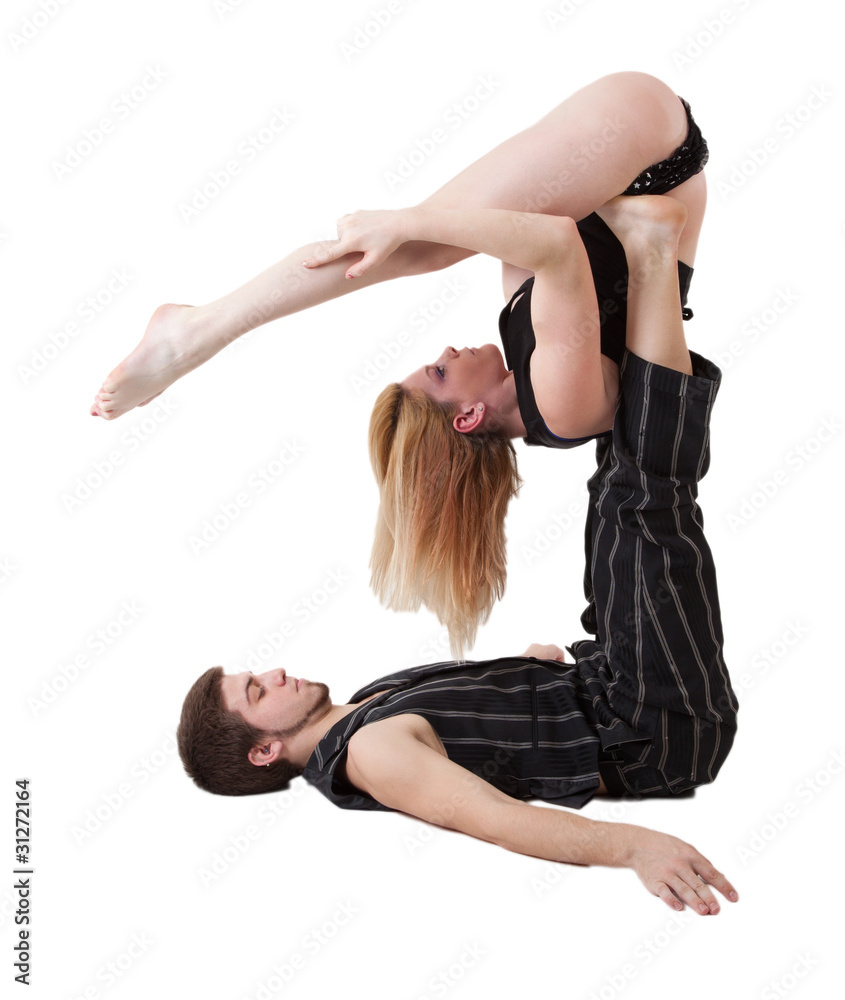 Fototapeta premium Young Couple Practices Acrobatic Balance