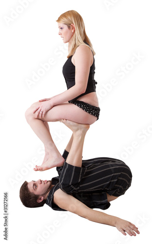 Young Couple Practices Acrobatic Balance