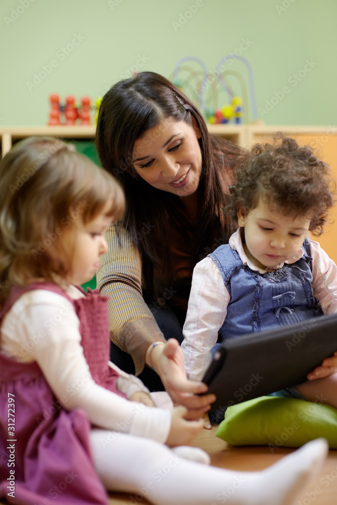 Teacher reading fairy tale to children at school Teacher reading fairy tale to children at school