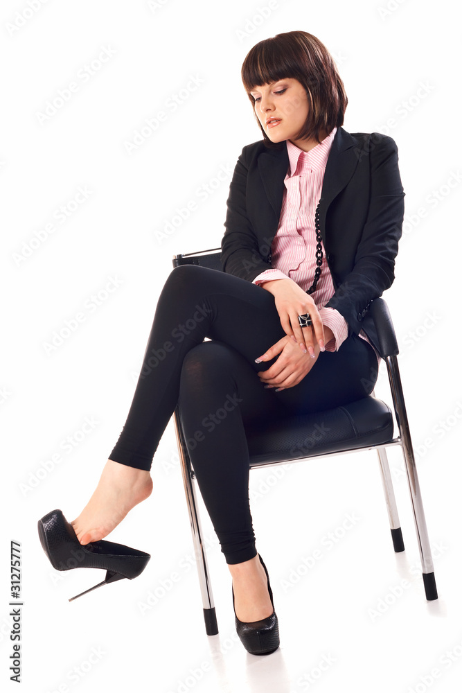 Model in black in chair Model in black in chair