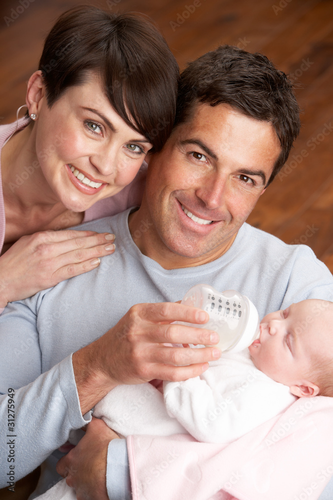 Portrait Of Parents Feeding Newborn Baby At Home Portrait Of Parents Feeding Newborn Baby At Home