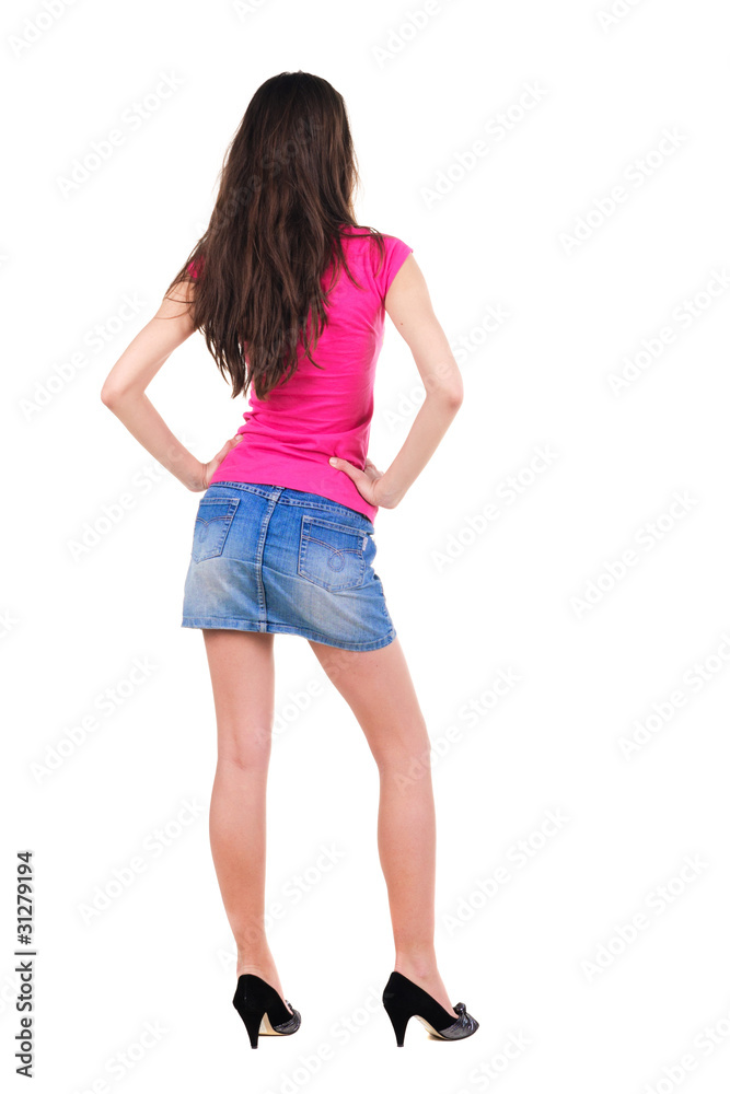 .Beautiful young woman looking at wall. Rear view. .Beautiful young woman looking at wall. Rear view.