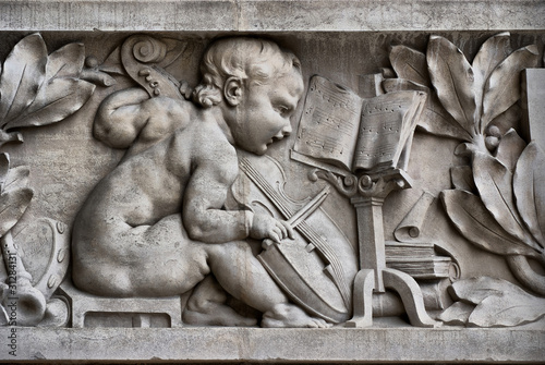 Child musician on a frieze photo