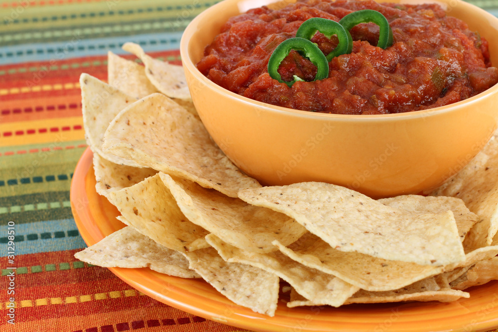 Salsa, jalapeno pepper slices and tortilla chips Salsa, jalapeno pepper slices and tortilla chips