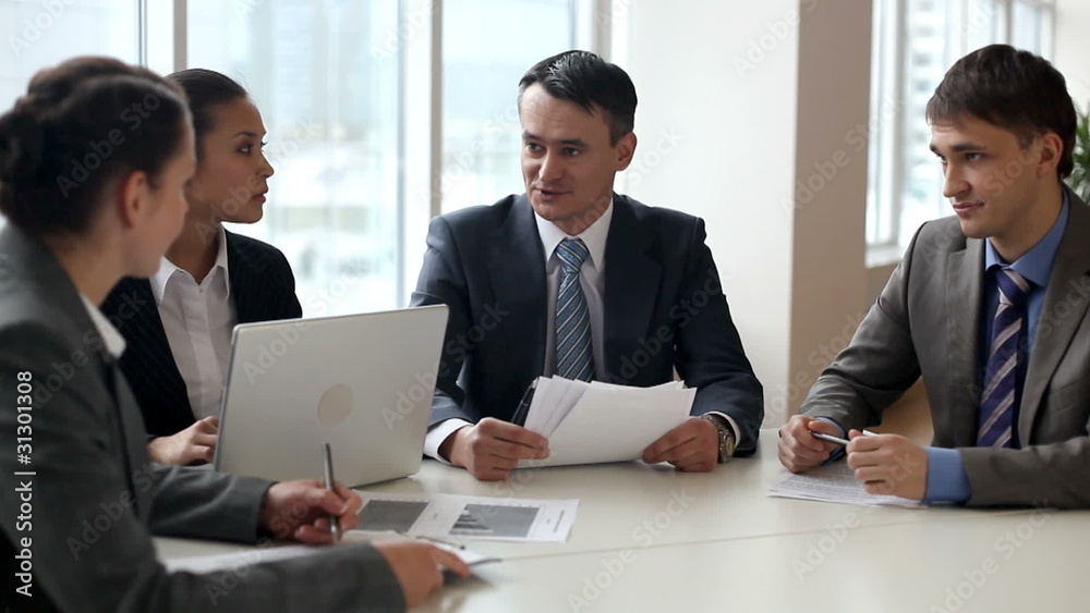 Businesspeople discussing project during briefing Businesspeople discussing project during briefing