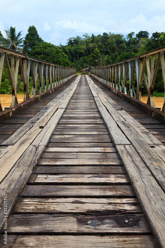 Old bridge over a brown river Old bridge over a brown river