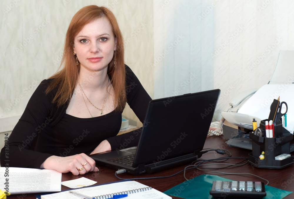 Beautiful woman working with laptop in office Beautiful woman working with laptop in office