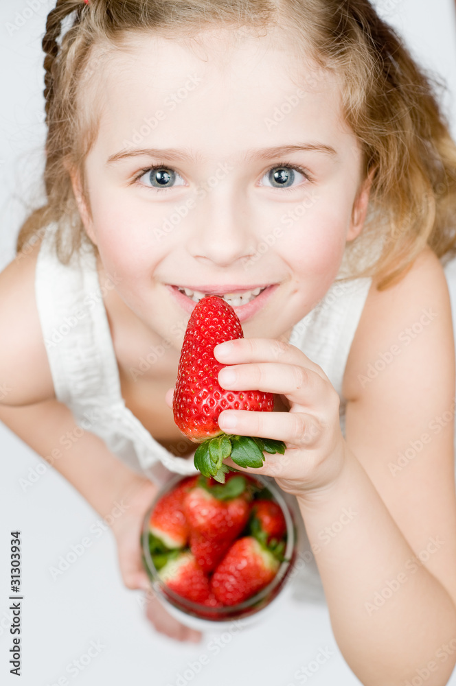 Strawberry time - girl eating strawberries Strawberry time - girl eating strawberries