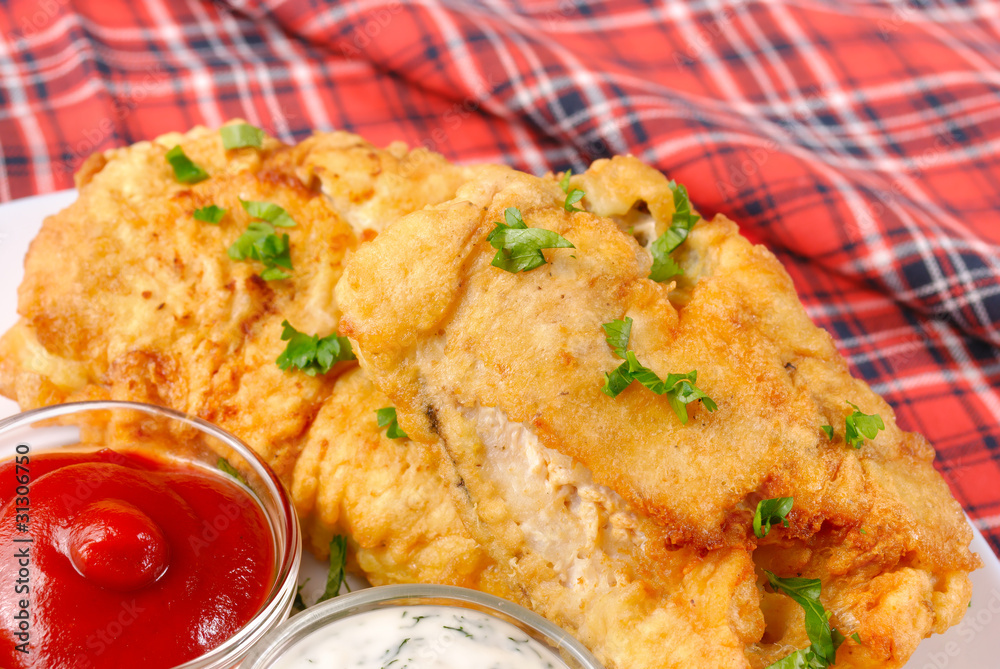 White plate with fried fish, mayonnaise and ketchup White plate with fried fish, mayonnaise and ketchup