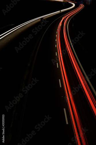 Cars moving fast on a night highway (motion blurred image)
