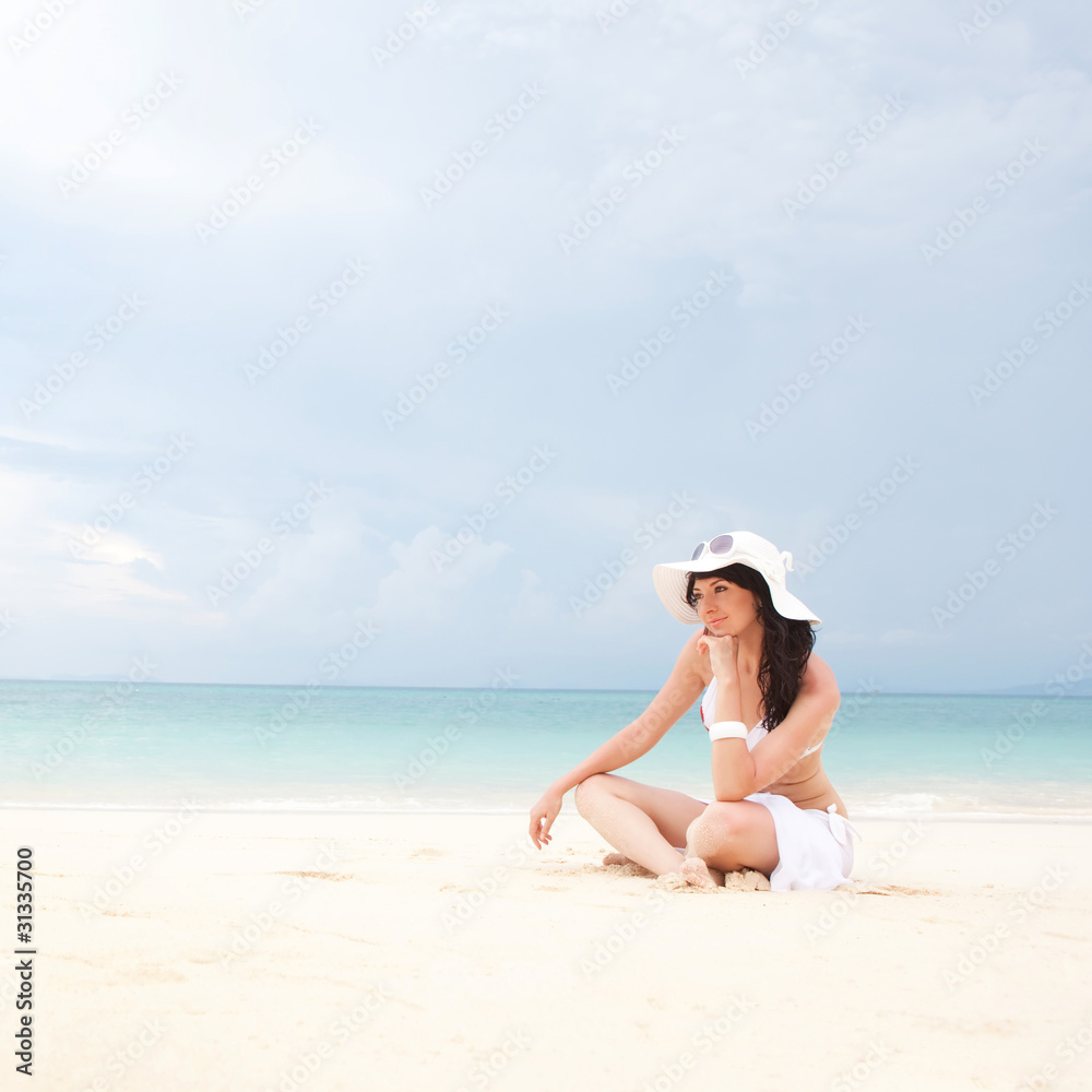 Young fashion woman on the beach