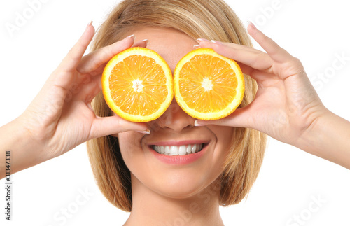 Portrait of a young redhead woman playing with oranges