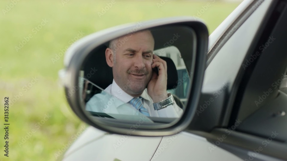 businessman calling on mobile phone in car businessman calling on mobile phone in car
