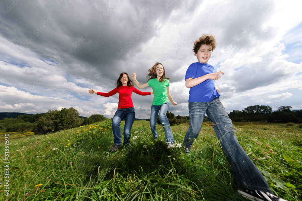 Active family - mother and kids running outdoor Active family - mother and kids running outdoor