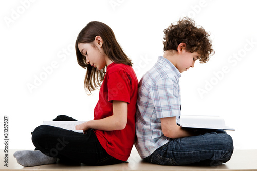 Girl and boy reading book isolated on white background