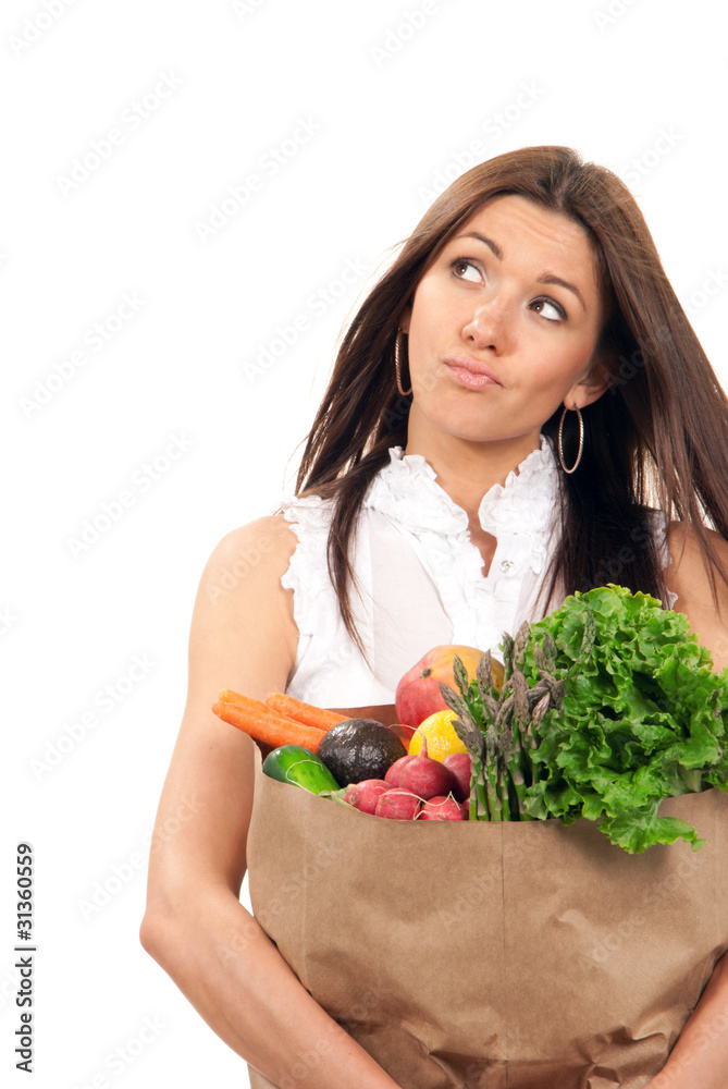 woman holding a shopping bag full of vegetarian groceries woman holding a shopping bag full of vegetarian groceries