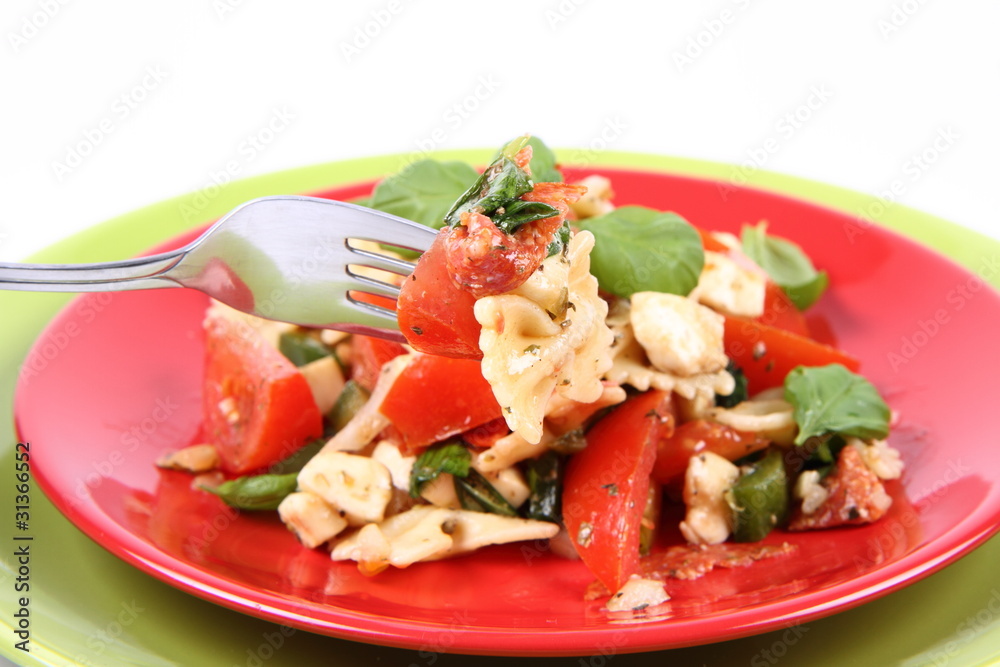 Salad being eaten - farfalle, tomato, salami, mozzarella, basil