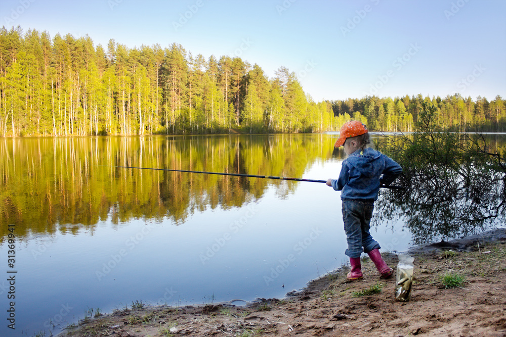 Girl on the lake fishing.