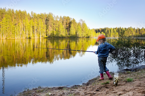 Girl on the lake fishing.