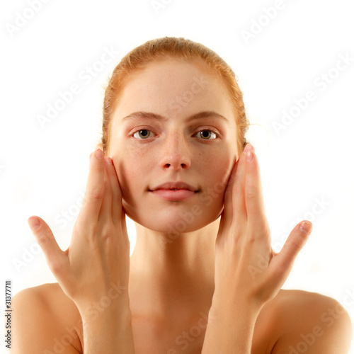 woman young beautiful no make-up touching face with her hands is