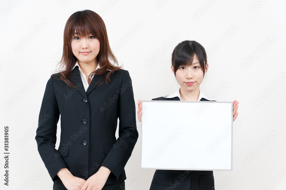 two asian businesswomen with blank whiteboard two asian businesswomen with blank whiteboard