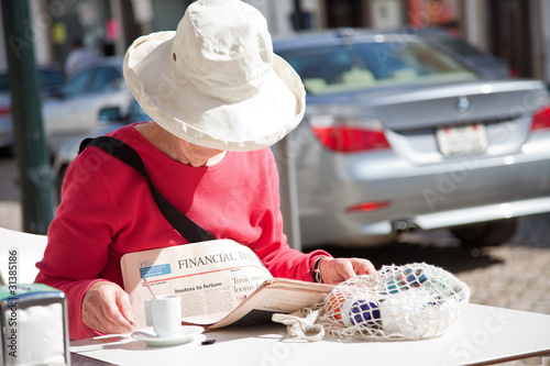 Leyendo el periódico en una cafetería de Tavira, Portugal photo