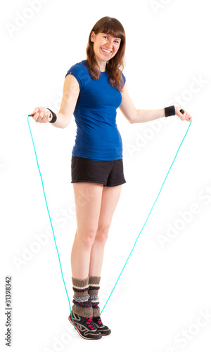 Young woman jumping on skipping rope