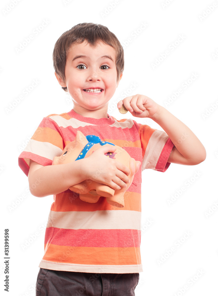 Litle boy puts the coin into the piggy bank Litle boy puts the coin into the piggy bank