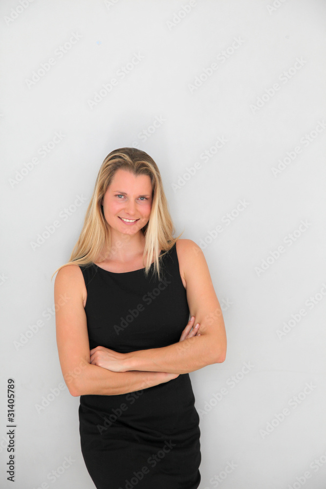 Beautiful businesswoman standing on grey background Beautiful businesswoman standing on grey background