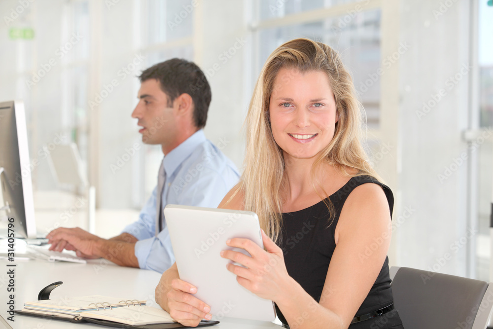 Businesswoman working in office with electronic tablet Businesswoman working in office with electronic tablet