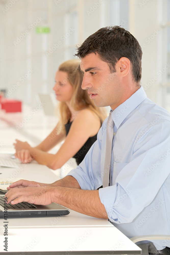 Office worker in front of laptop computer Office worker in front of laptop computer