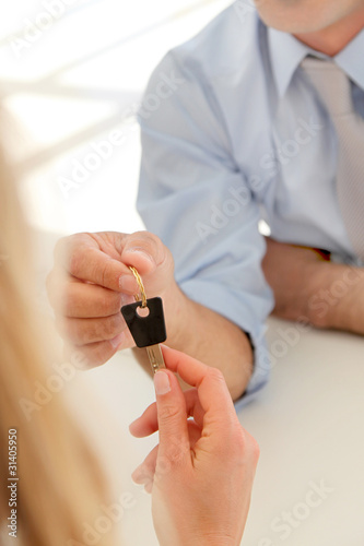 Closeup on hands giving car key