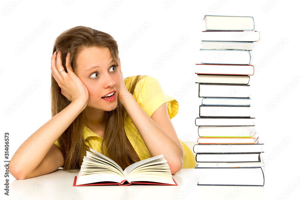 Young woman looking at stack of books Young woman looking at stack of books