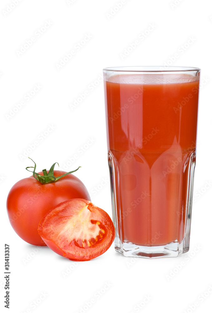 Drinking glass filled with tomato juice and tomatoes near Drinking glass filled with tomato juice and tomatoes near