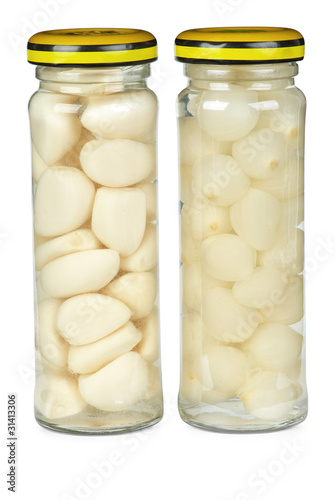 Glass jars with marinated garlic and onions