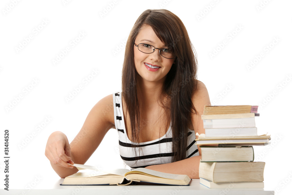 Young student woman with lots of books studing. Young student woman with lots of books studing.