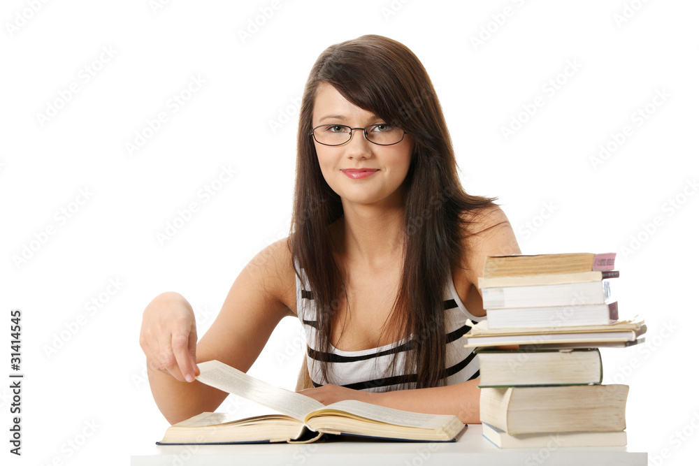 Young student woman with lots of books studing. Young student woman with lots of books studing.