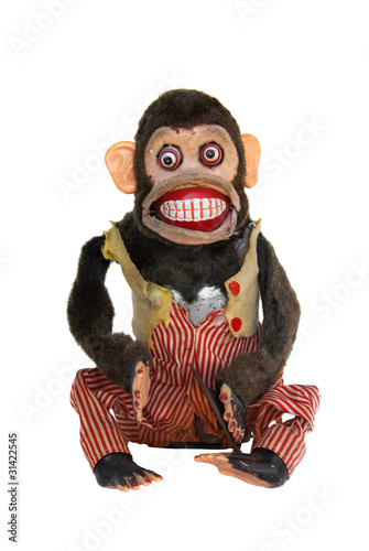 Mechanical chimp with ripped vest, uneven eyes