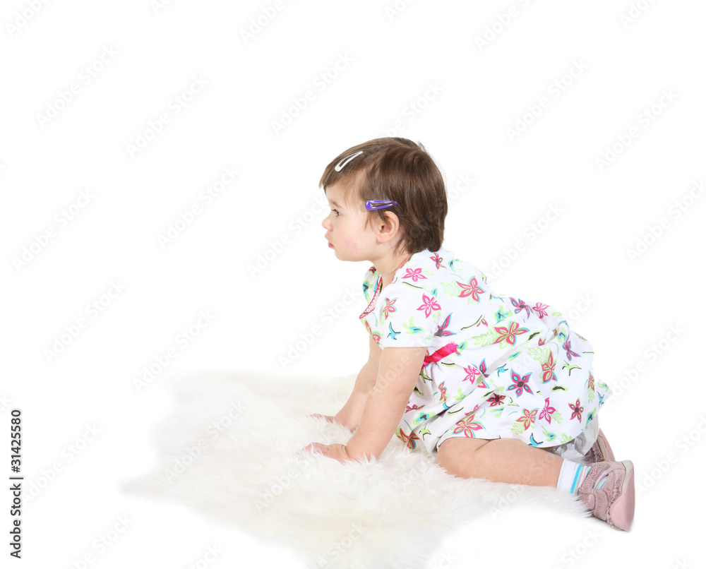 little girl sits on a white sheep skin little girl sits on a white sheep skin